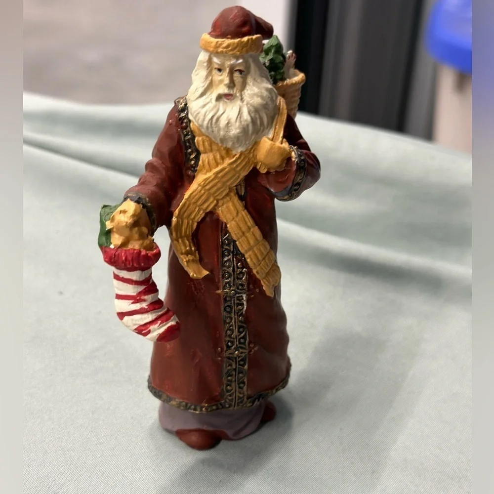Santa collectible figure in plaster. Santa carries a stocking & basket of treats